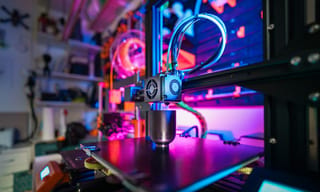 3D printer extruding filament in a home workshop
