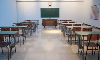 Empty classroom with rows of desks and a green chalkboard - Photo by Ivan Aleksic on Unsplash
