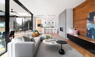 Modern new construction home interior with new furniture, hardwood flooring, and fresh finishes that release VOCs