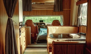 RV camper interior with seating area and large window