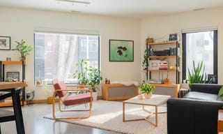 Bright, modern living room with natural light, plants, and open seating area. Photo by Unsplash