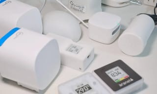 Affordable air quality monitor on a desk next to a window