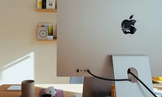 CO2 monitor displaying air quality readings on a home desk