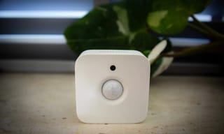 Indoor air quality monitor displaying readings in a modern living room