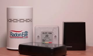 Radon detector displaying readings in a home basement