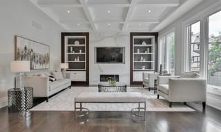 A spacious, bright modern living room with large windows and clean air