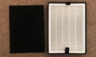 Dark activated carbon filter and white pleated HEPA filter side by side showing the two main air purifier filter types