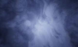 Wisps of smoke swirling in dark blue light - Photo by Logan Voss on Unsplash