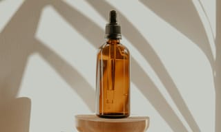 Essential oil diffuser releasing mist in a living room with soft natural light