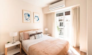 Air quality monitor next to a HEPA air purifier showing real-time PM2.5 readings