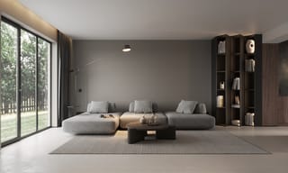 A bright, modern living room with a large window and abundant natural light, representing clean indoor air