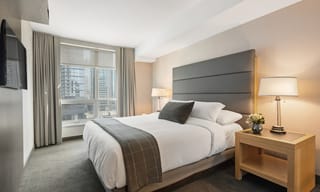 A bright, clean bedroom with soft natural light and fresh air