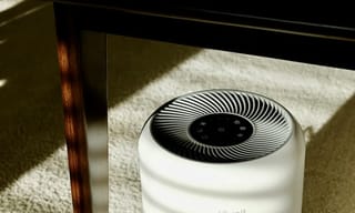 White air purifier device in a modern room, showcasing HEPA filtration technology