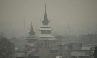 Misty view of city rooftops with haze from particulate matter pollution obscuring the skyline
