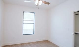 Bright room interior with ceiling fan and window, showing an ideal open space for air quality monitor placement