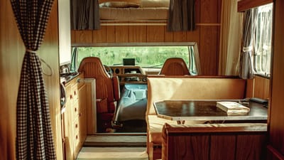 RV camper interior with seating area and large window