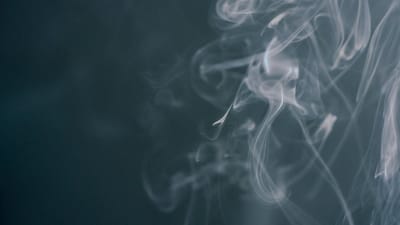 White smoke wisps rising against a dark background - Photo by Kseniya Budko on Pexels