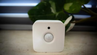 Indoor air quality monitor displaying readings in a modern living room