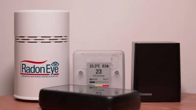 Radon detector displaying readings in a home basement