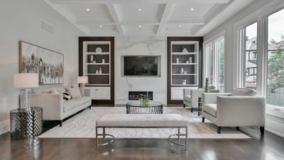 A spacious, bright modern living room with large windows and clean air