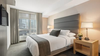 A bright, clean bedroom with soft natural light and fresh air