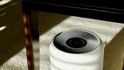 White air purifier device in a modern room, showcasing HEPA filtration technology