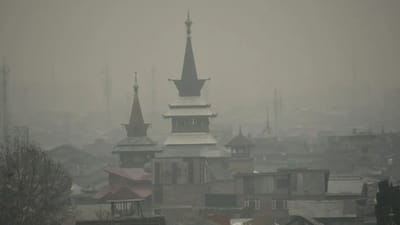 Misty view of city rooftops with haze from particulate matter pollution obscuring the skyline
