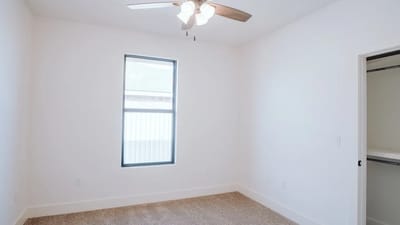 Bright room interior with ceiling fan and window, showing an ideal open space for air quality monitor placement