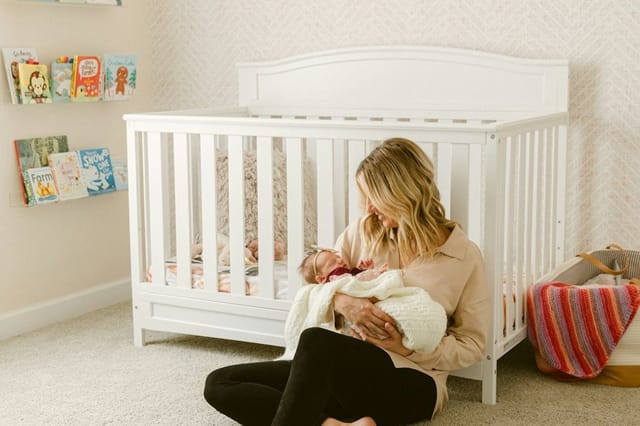 Mother sitting on the floor with her baby, enjoying clean air in a bright room