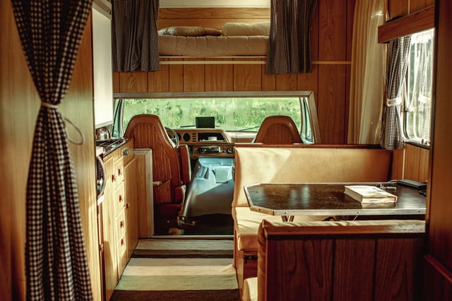 RV camper interior with seating area and large window