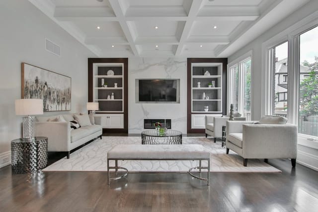 A spacious, bright modern living room with large windows and clean air