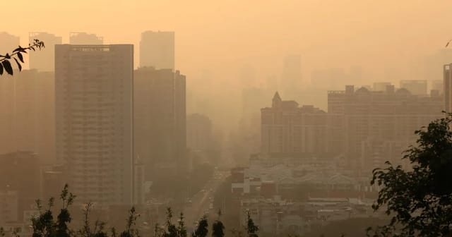 City skyline shrouded in hazy warm light, illustrating the air quality conditions measured by the AQI