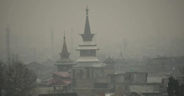 Misty view of city rooftops with haze from particulate matter pollution obscuring the skyline